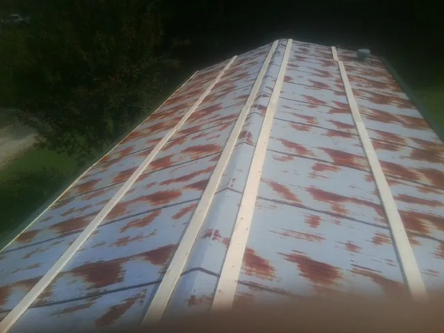Rusted metal roof panels with new wood purlins before replacement — Storm Damage Roof Repair in Leighton by Roofing Brothers